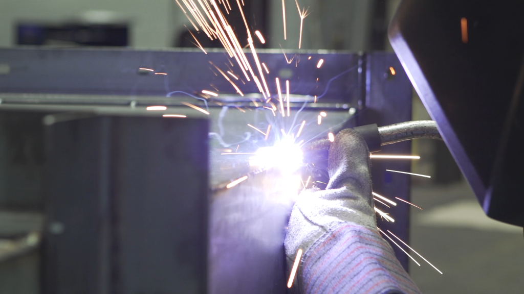A photo of a welder welding a metal